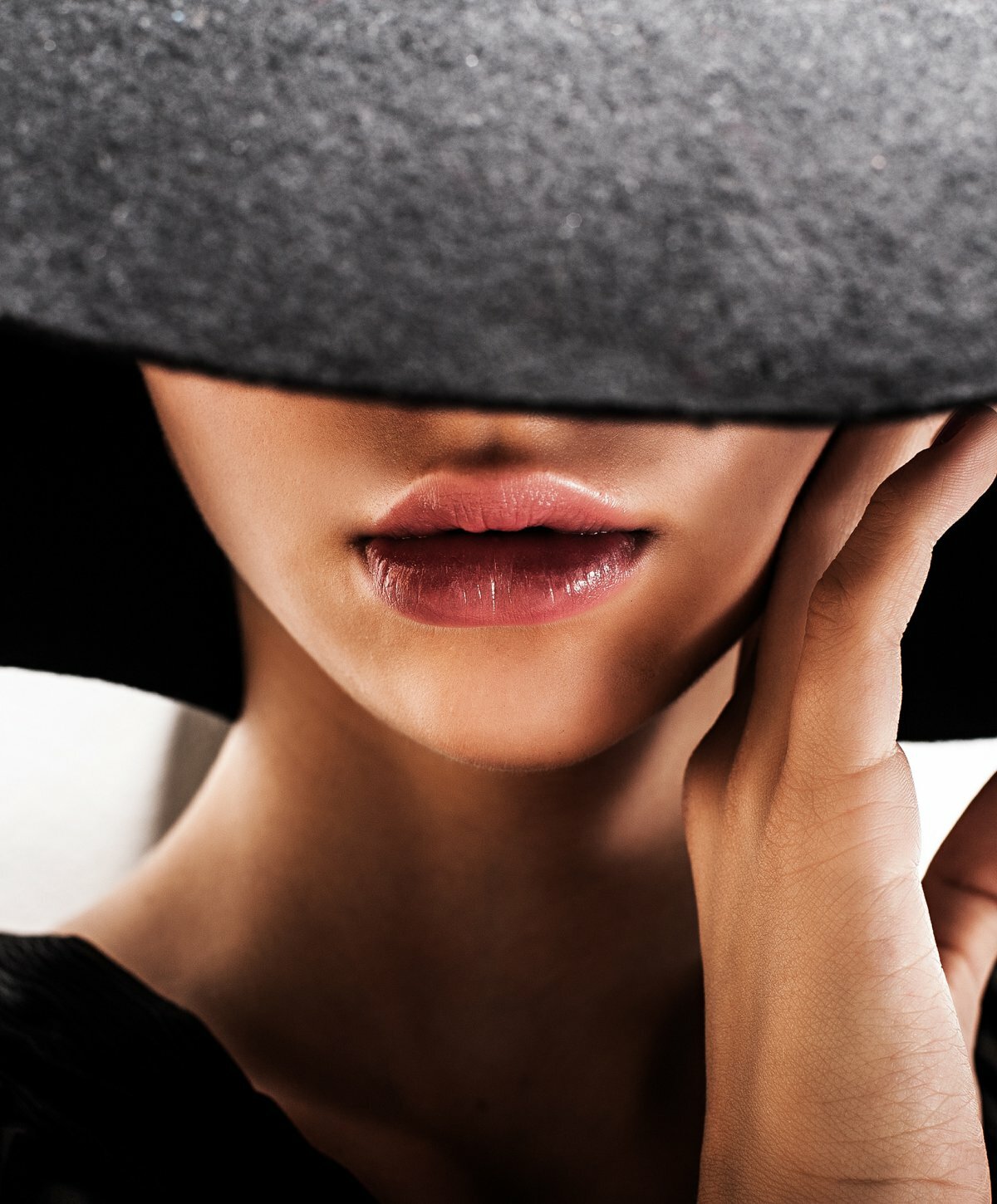 Restylane Refyne client with a black hat covering her face