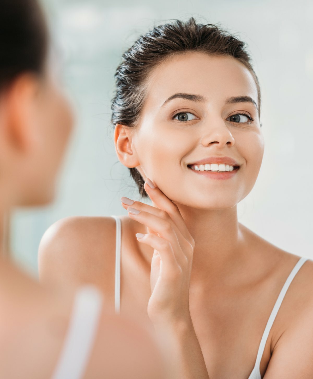 Microneedling client looking in a mirror